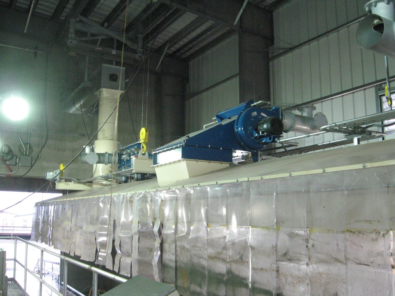 Dust collectors with fluted filter packs are much smaller than conventional dust collectors, which allows the collector to be integrated into a truck load-out hood.